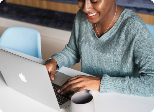 Persona usando un portátil en un escritorio, representando la plataforma de donaciones en línea y los servicios digitales de Worldcoo